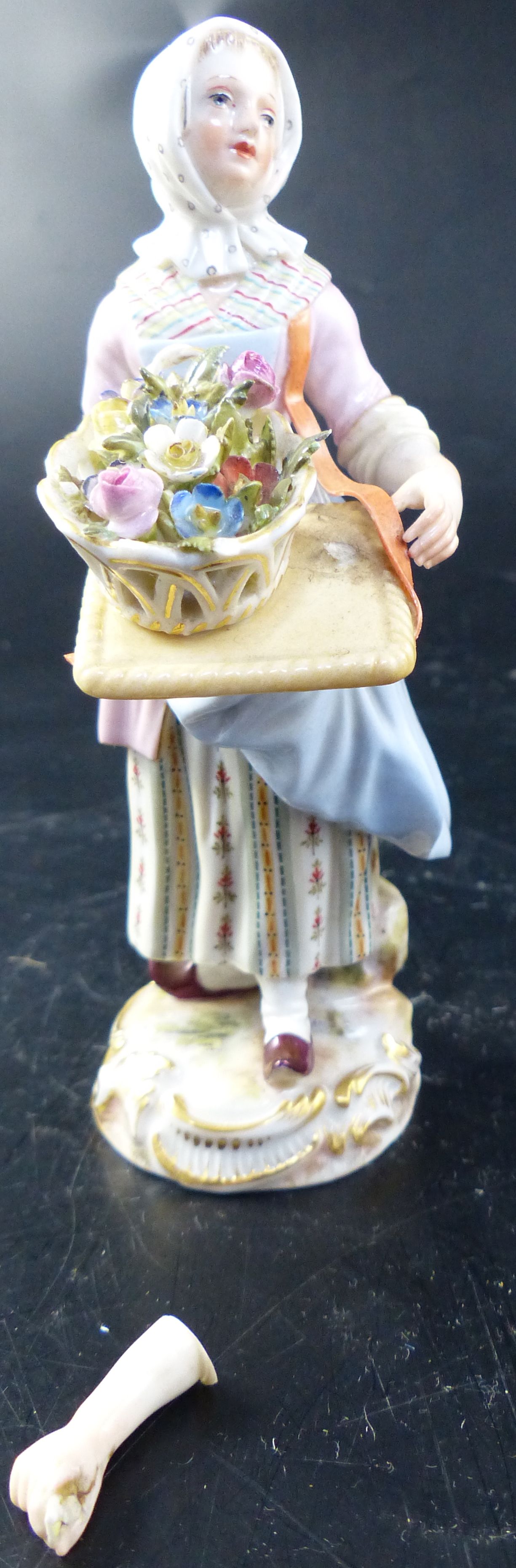 A pair of early 20th century Meissen figures of street vendors, 14cm (a.f.)